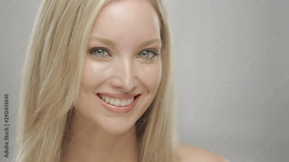 Caucasian blonde woman in studio smiling and laughing at camera Caucasian blonde woman in studio smiling and laughing at camera