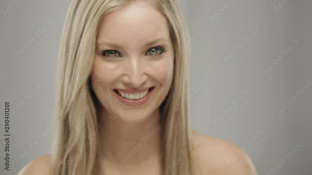 Caucasian blonde woman in studio smiling and laughing at camera Caucasian blonde woman in studio smiling and laughing at camera
