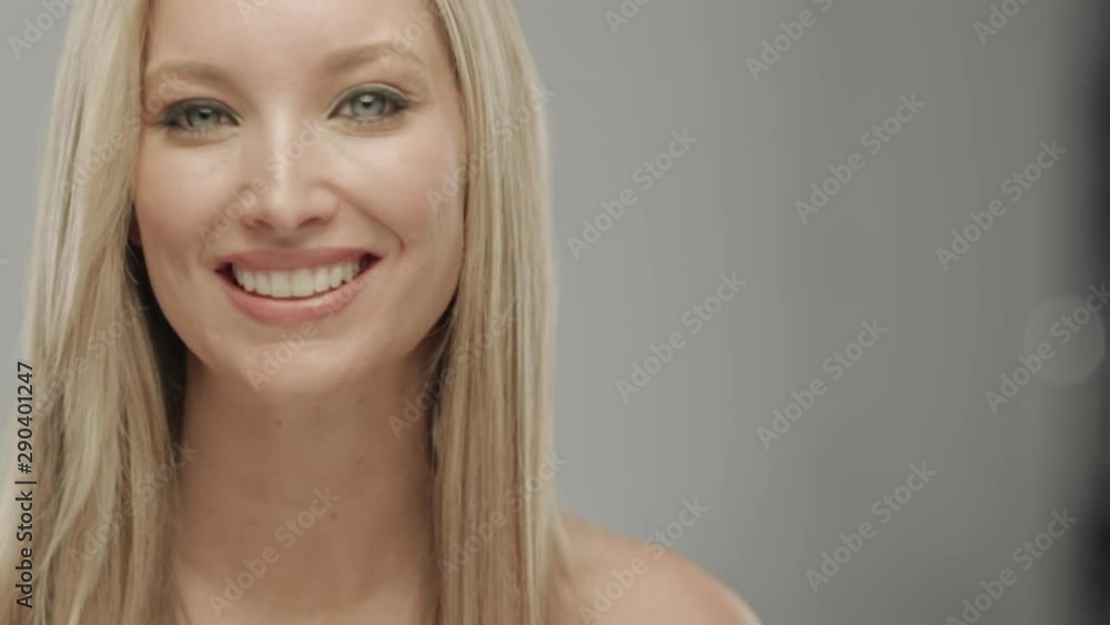 Caucasian blonde woman in studio smiling at camera Caucasian blonde woman in studio smiling at camera