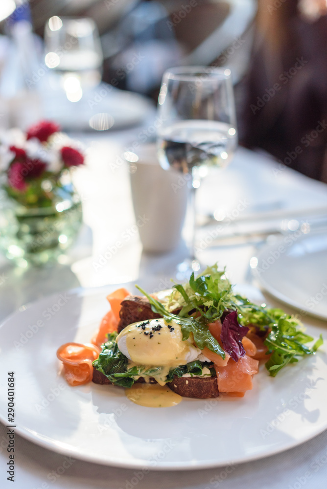 Poached egg with smoked salmon on rye bread. Brunch in restaurant Poached egg with smoked salmon on rye bread. Brunch in restaurant