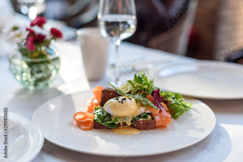 Poached egg with smoked salmon on rye bread. Brunch in restaurant