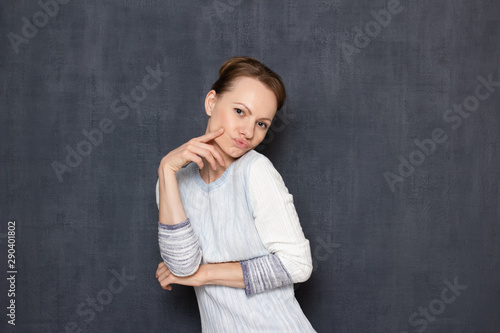 Portrait of comic flirty woman imitating sexy photo pose