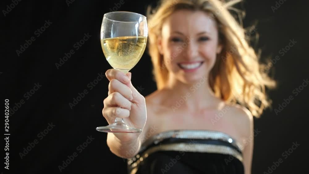 Smiling Caucasian woman holding glass of white wine Smiling Caucasian woman holding glass of white wine