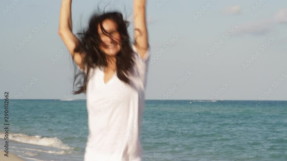 Hispanic woman dancing on beach Hispanic woman dancing on beach