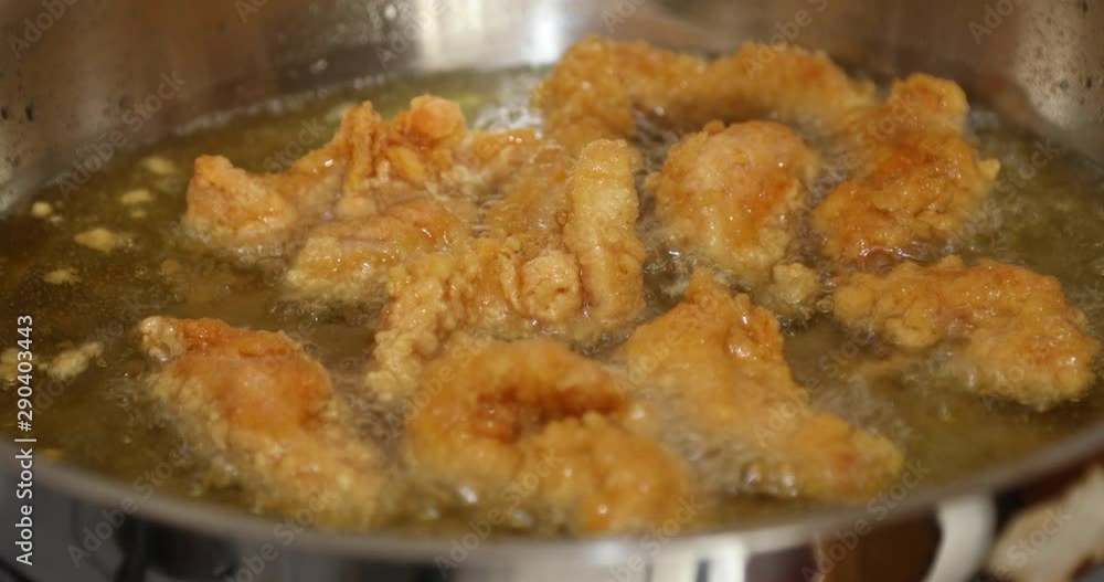 Golden color chicken wings cooking into a wok Golden color chicken wings cooking into a wok