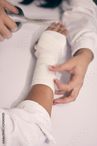 a woman's arm is bandaged with a white bandage and a first aid aid