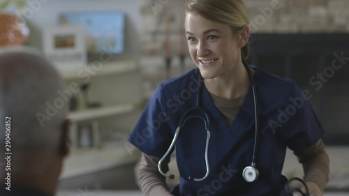 Caregiver laughing with patient in home