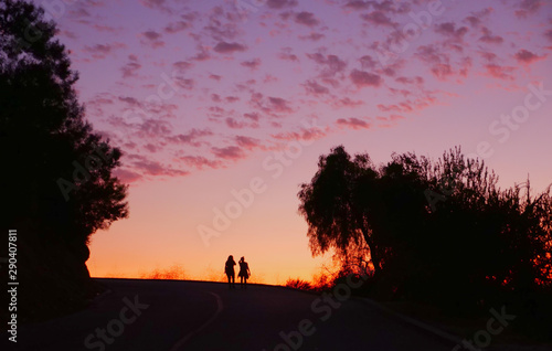 Two Silhouette Hikers at Sunset