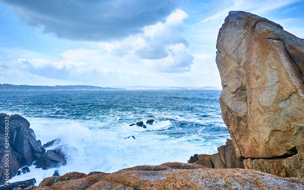 Galician seascape in Coitelada, Ares, La Coruña, Spain. Sea with a lot of waves breaking on the rocks