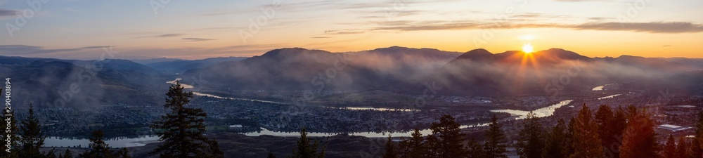 Fototapeta premium Beautiful Panoramic View of a Canadian City, Kamloops, during a colorful summer sunrise. Located in the Interior British Columbia, Canada.
