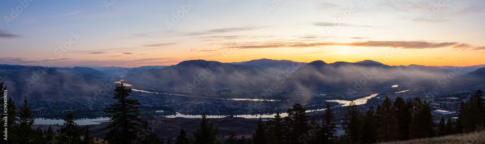 Beautiful Panoramic View of a Canadian City, Kamloops, during a colorful summer sunrise. Located in the Interior British Columbia, Canada.