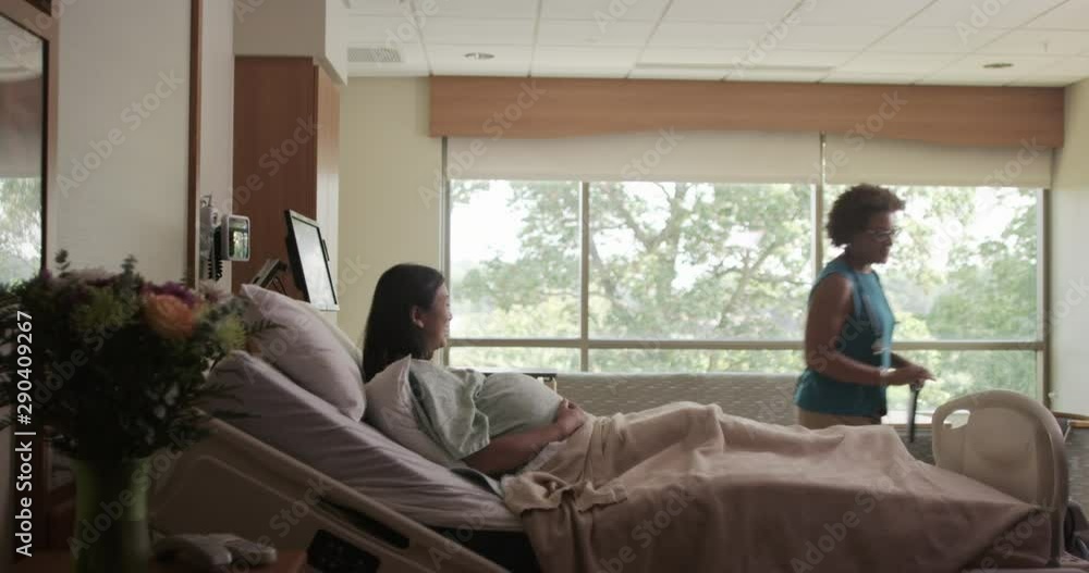 Doctor with digital tablet talking to expectant mother then leaving Doctor with digital tablet talking to expectant mother then leaving