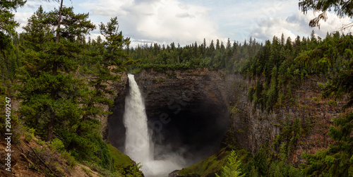 Beautiful Panoramic View of a waterfall, Helmcken Falls, in the Canadian Mountain Landscape during a sunny and cloudy day. Taken in Wells Gray Provincial Park, near Clearwater, BC, Canada.