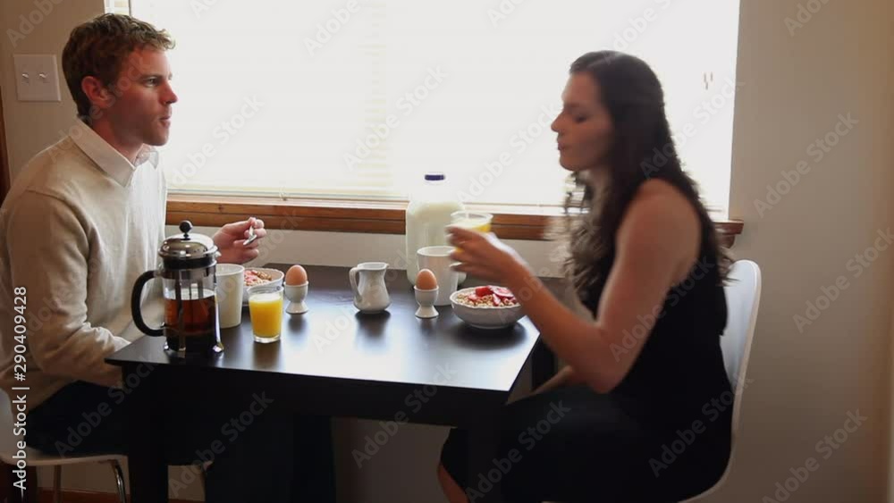 Young Caucasian professional couple enjoying breakfast together Young Caucasian professional couple enjoying breakfast together