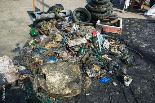 Garbage on the beach in the big city. Dirty sea. Environmental pollution. Ecological problem.