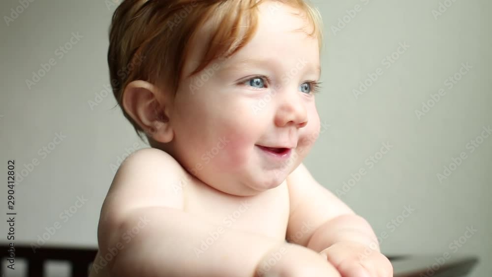 Smiling Caucasian baby boy standing in crib Smiling Caucasian baby boy standing in crib