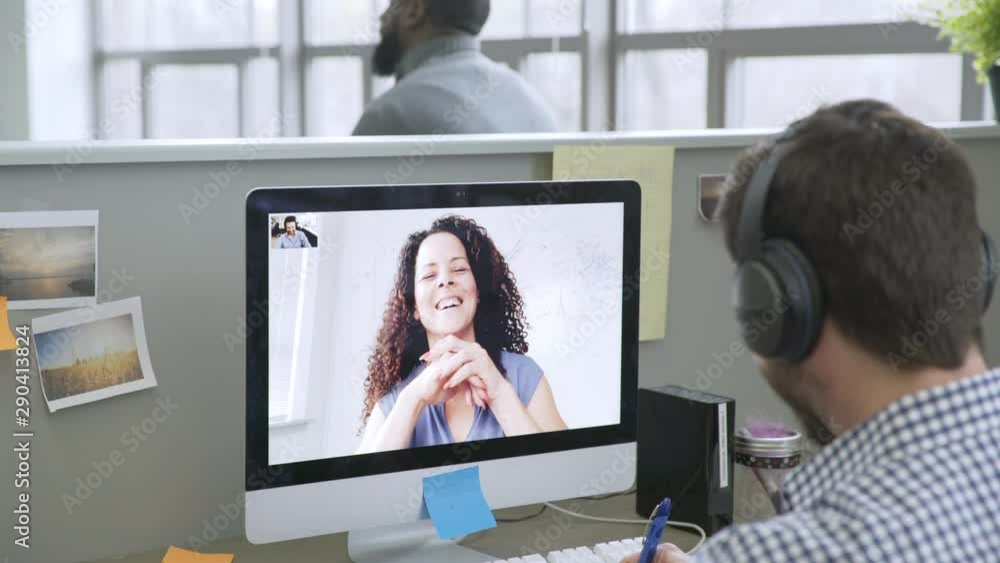 Businessman video chatting with businesswoman in startup office Businessman video chatting with businesswoman in startup office