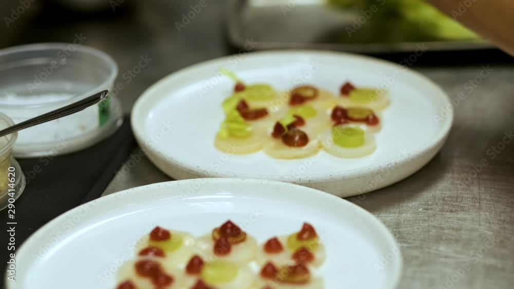 Close-up shot of a chef decorating a plate before serving it Close-up shot of a chef decorating a plate before serving it