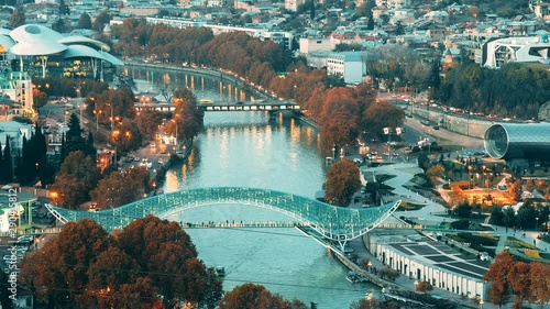 Tbilisi, Georgia. Top View Of Famous Landmarks In Night Illuminations. Georgian Capital Skyline Cityscape. City During Sunset And Night Illuminations. Day To Night Transition photo