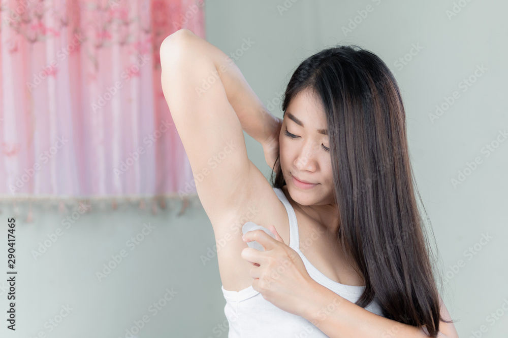 Close up of young girl doing hygienic procedure. She applying antiperspirant on armpit. Close up of young girl doing hygienic procedure. She applying antiperspirant on armpit.