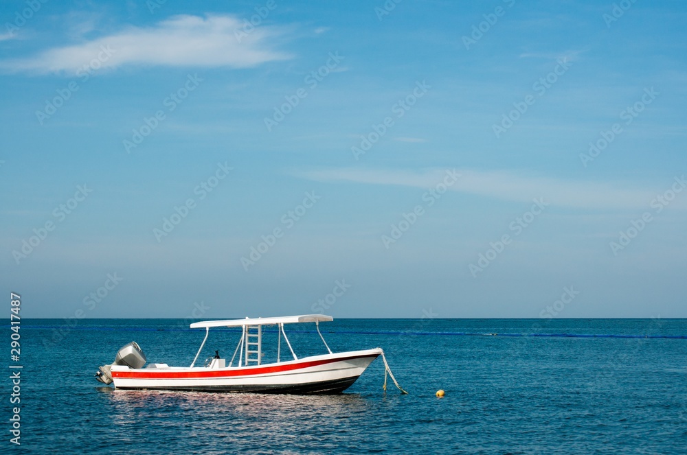 Small boat at the Caribbean sea, Mexico, coral reef snorkeling, negative space