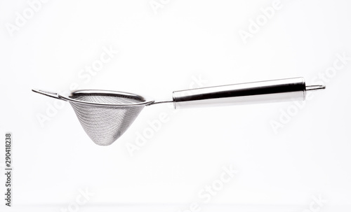 Stainless steel strainer in white background