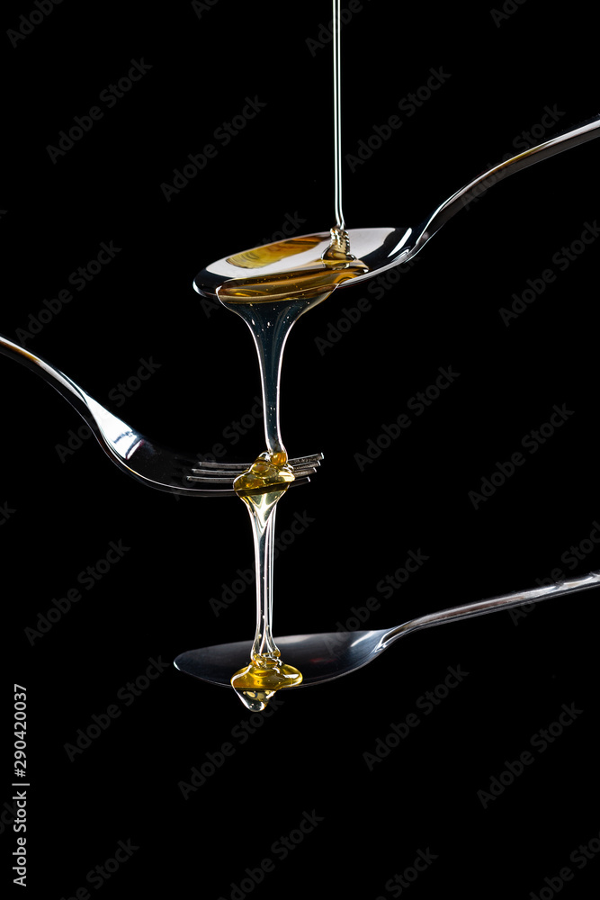golden sweet honey dripping from spoon golden sweet honey dripping from spoon