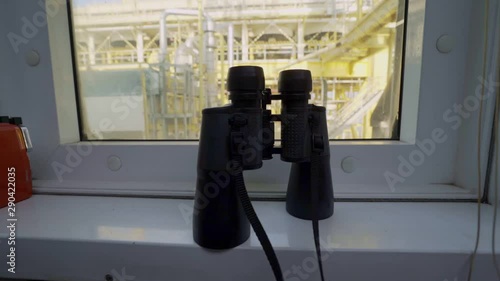 binoculars infont of petrochemical plant photo