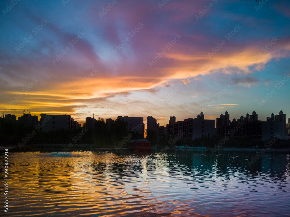 Golden sunset over a lake of a Shenyang residential lot