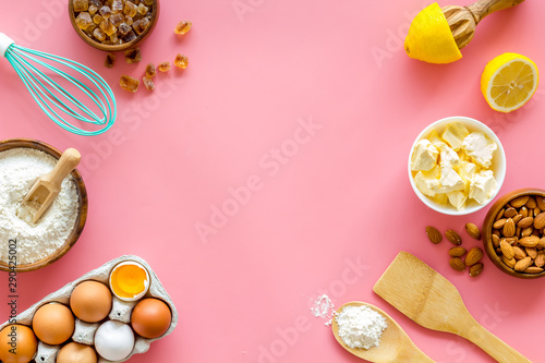 Baking background. Dough ingredients on pink background top view copy space