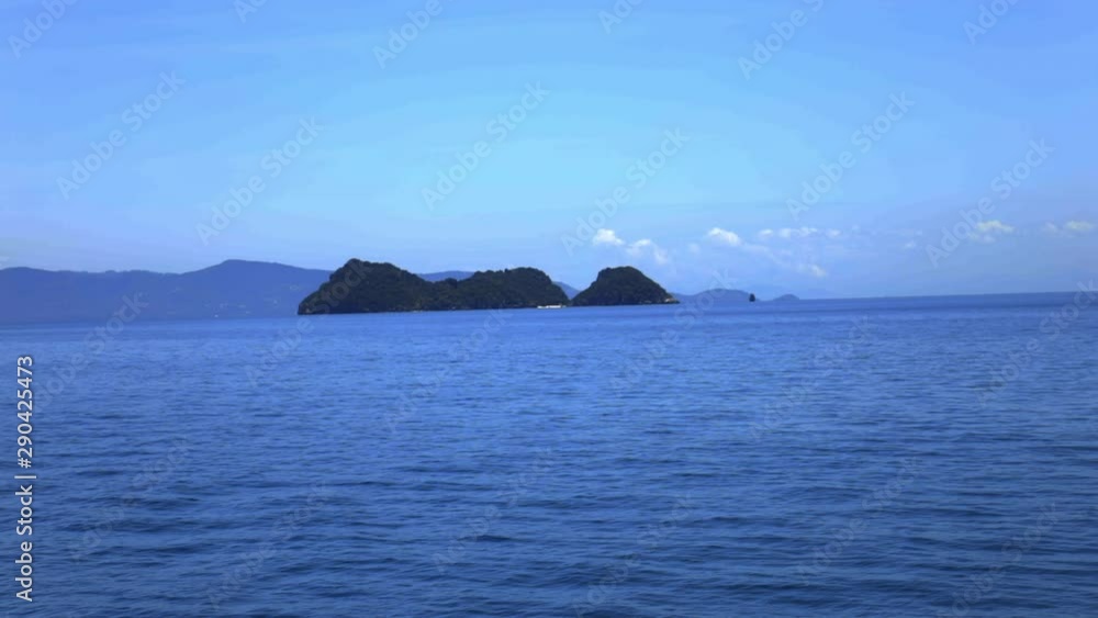 Looking at the sea, island and sky from the sea. (Slow motion - Angle 009) Looking at the sea, island and sky from the sea. (Slow motion - Angle 009)