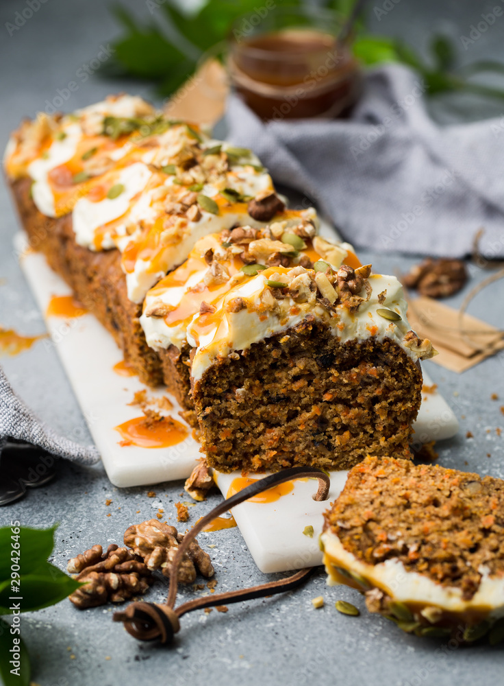 Carrot cake (bread, pie) with nuts, cheese cream and salted caramel. Favorite delicious coffee cake