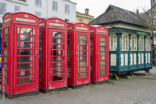 Four red telephone kiosks in a row