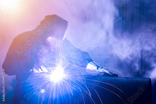 фотографія Industrial welders, industrial steel pipe parts, welding workers, steel workpiec