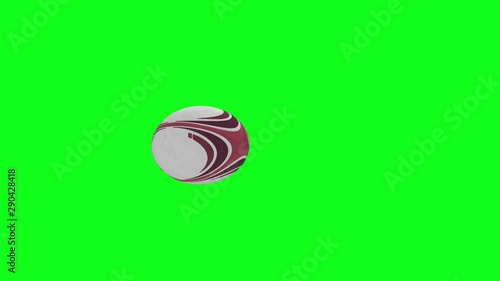 Rugby ball animation.  Red rugby ball animation, spinning slowly from left to right at a slight angle, with a green screen background.
