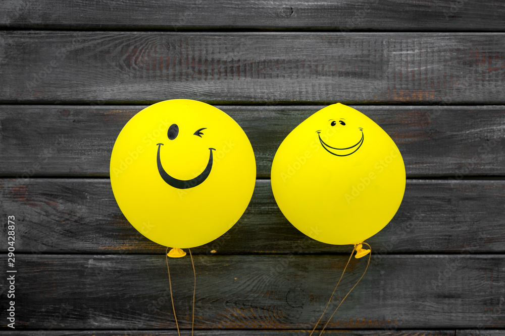 Naklejka Happiness emotion. Yellow balloon with smile on blue background top view