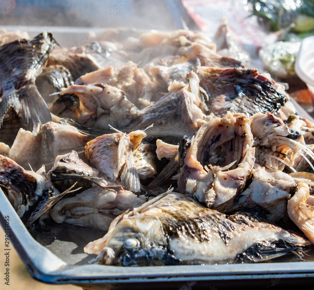 Fresh boiled river fish. Steam from pieces of fish, food on the street. Fresh boiled river fish. Steam from pieces of fish, food on the street.