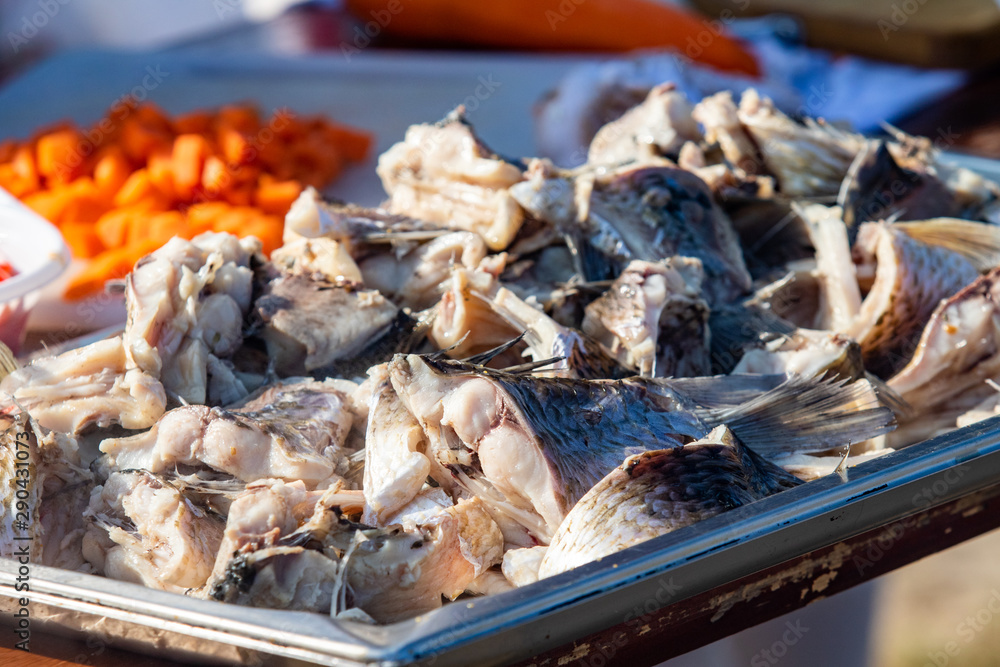 Fresh boiled river fish. Steam from pieces of fish, food on the street. Fresh boiled river fish. Steam from pieces of fish, food on the street.