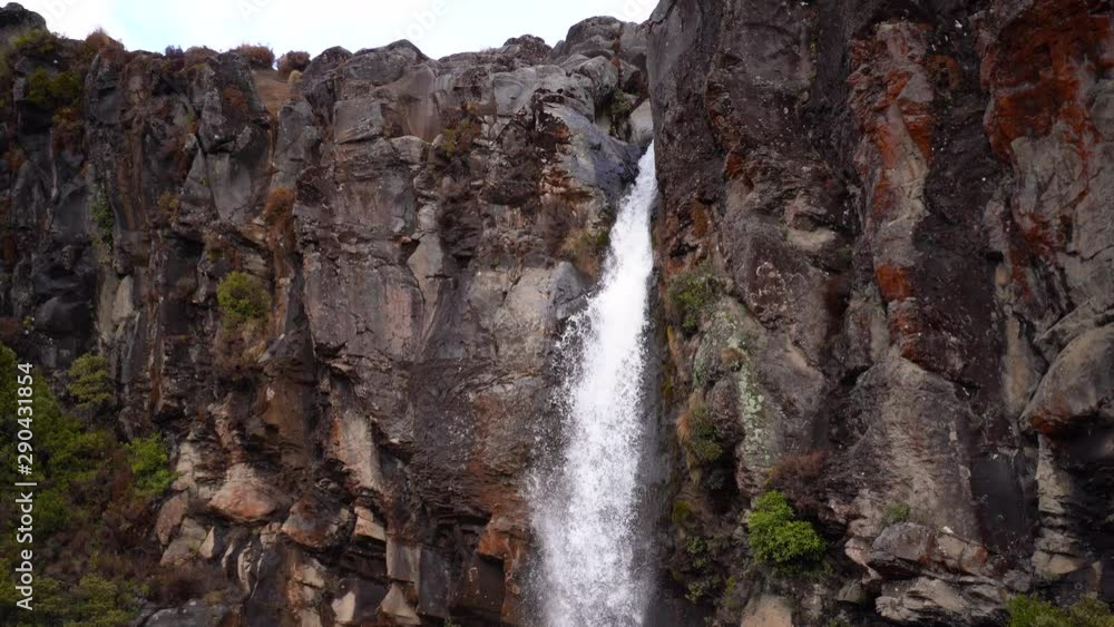 Large waterfall on volcano flowing into rock pool in mountain range while hiking in summers day Large waterfall on volcano flowing into rock pool in mountain range while hiking in summers day