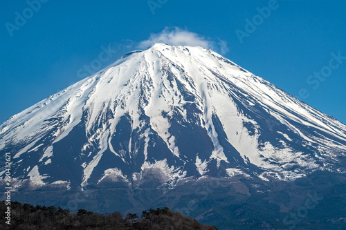 Top Mountain Fuji is covered with snow and blue sky background.