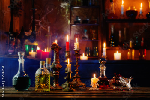 magic potions in bottles on wooden background
