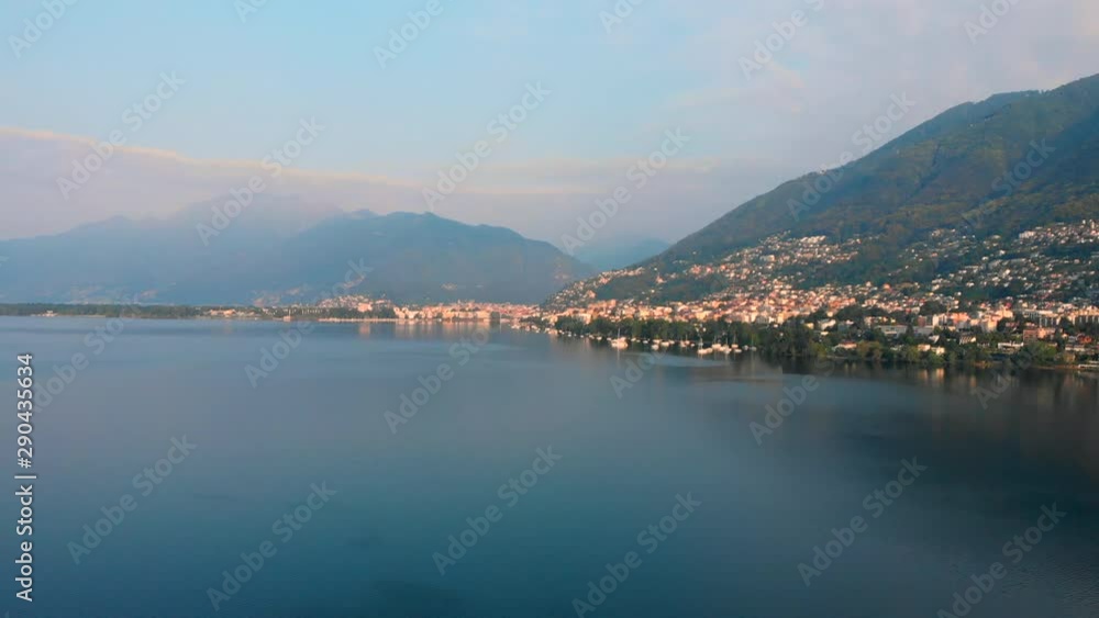 Aerial approach of the lakeside of Locarno with mountains in the background, Switzerland, Lake Maggiore Aerial approach of the lakeside of Locarno with mountains in the background, Switzerland, Lake Maggiore