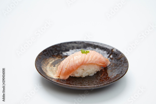 Grilled salmon sushi topped with sweet sauce isolated on white background. 