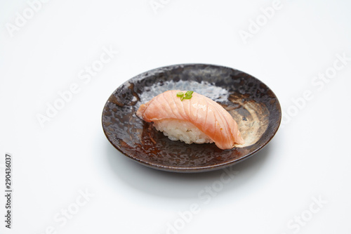 Grilled salmon sushi topped with sweet sauce isolated on white background. 
