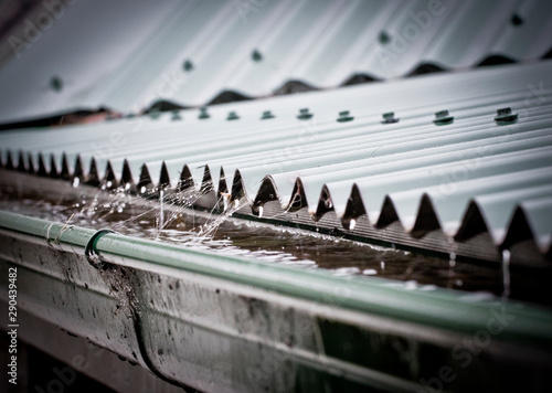 Rain on a corrugated iron roof collecting in a gutter photo