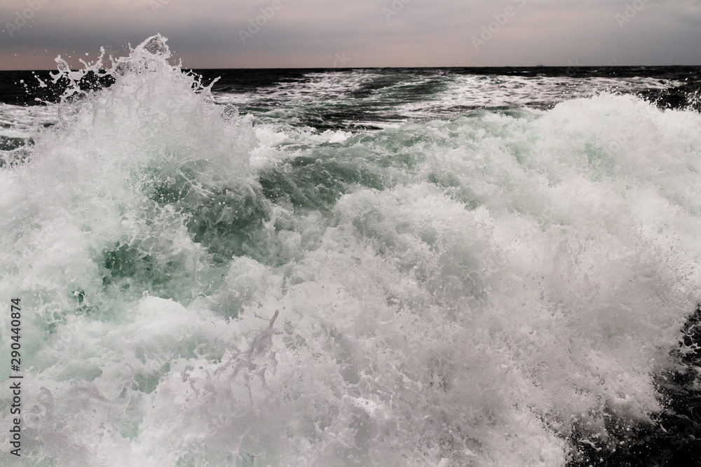 Fototapeta premium Fast speed in the sea . Waves, foam and wake caused by cruise ship in the sea