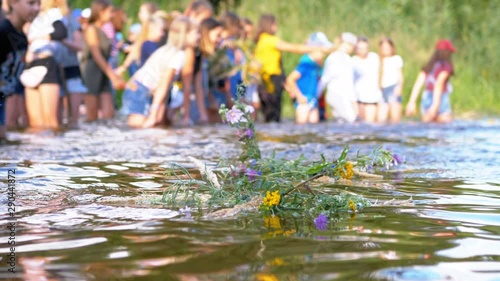 Celebration of Ivan Kupala. Girls and women lay wreaths on the water. Folk tradition photo