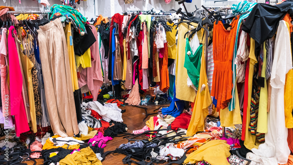Messy clearance section in a clothing store, with colorful