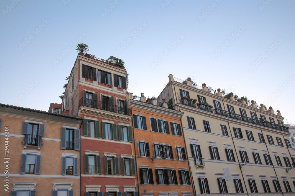 Colored facades of houses in a street of Rome