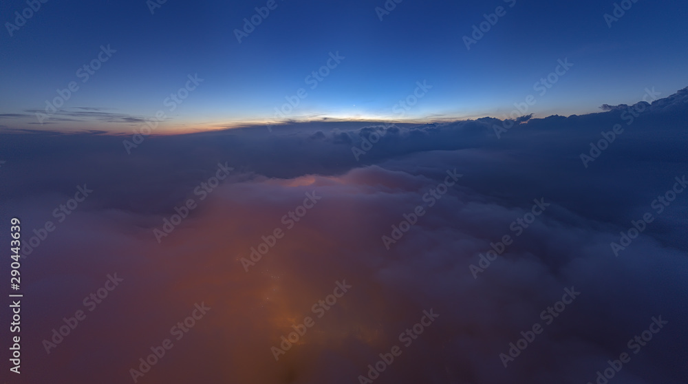 city light from ground visible from above the cloud. noise visible due to low light photography city light from ground visible from above the cloud. noise visible due to low light photography